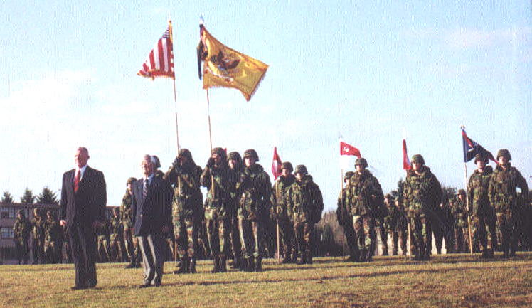 BG(R) Stan Cherrie and CSM(R) Frank Mouri stand front center to be installed as Honorary Colonel and CSM of the Regiment Guidons of Troops B, C and D are visible to right rear of the Color Guard The blue guidon is that of the Squadron's attached Antitank Company Who said the sun never shines at Fort Lewis in February? For the Centennial of the 14th Cavalry it did.